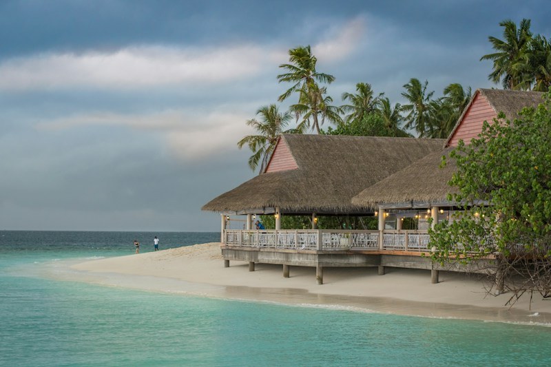 A peaceful wooden verandah looking out over coastal waters at sundown at Sepoe Guest House